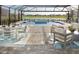 Beautiful outdoor living space with a pool and lake view, perfect for relaxation at 17716 Roost Pl, Lakewood Ranch, FL 34211