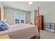 Cozy bedroom featuring a four-poster bed, natural light, and wood dresser at 200 Main St # 202, Dunedin, FL 34698