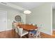 Formal dining area with hardwood floors and contemporary lighting and entry door at 200 Main St # 202, Dunedin, FL 34698