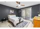 Cozy bedroom featuring neutral decor, a ceiling fan, and natural light from a window at 2085 Lynnwood Ct, Dunedin, FL 34698