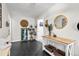 Stylish foyer with black tiled floors, white walls, and decorative table at 2085 Lynnwood Ct, Dunedin, FL 34698