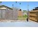 Backyard with multiple wooden gates, some new and some old, providing access to the property at 2222 Harper St, Tampa, FL 33605