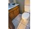 Small bathroom featuring tiled flooring, and a wooden vanity, and toilet at 2222 Harper St, Tampa, FL 33605