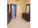 Bedroom featuring wood furniture, neutral walls, tiled floor, and a doorway to the bathroom at 2222 Harper St, Tampa, FL 33605