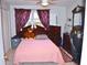 Comfortable bedroom featuring a bed with plush teddy bear, complemented by dark wood furnishings at 2222 Harper St, Tampa, FL 33605
