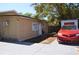 View of the property's exterior highlighting the driveway, neutral walls, and functional design at 2222 Harper St, Tampa, FL 33605