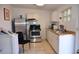 Kitchen with stainless steel appliances, tiled floor, white cabinets, and countertops and ample natural light at 2222 Harper St, Tampa, FL 33605