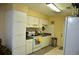 Kitchen featuring white cabinets, appliances, tiled flooring, with neutral walls and plenty of counter space at 2222 Harper St, Tampa, FL 33605
