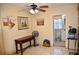 Bright room with tile floors, a vintage-style desk, and an open doorway to the bathroom at 2222 Harper St, Tampa, FL 33605