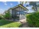 Backyard view of the screened-in lanai and lush landscaping at 31820 Blythewood Way, Wesley Chapel, FL 33543