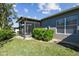 Backyard view of the screened-in lanai and siding of the home at 31820 Blythewood Way, Wesley Chapel, FL 33543