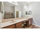 Bathroom featuring double sinks with ample counter space and a glass-enclosed shower at 31820 Blythewood Way, Wesley Chapel, FL 33543
