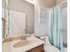 Neutral bathroom featuring vanity, sink, toilet, and shower with a blue shower curtain at 31820 Blythewood Way, Wesley Chapel, FL 33543