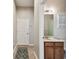 Half-bathroom and hallway with decorative art hanging on the wall at 31820 Blythewood Way, Wesley Chapel, FL 33543