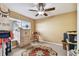 Spare bedroom with a ceiling fan, ceramic tile flooring, and natural light from the window at 31820 Blythewood Way, Wesley Chapel, FL 33543