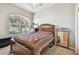 Cozy bedroom features large window, plush carpet and decorative furniture at 31820 Blythewood Way, Wesley Chapel, FL 33543