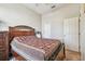 Inviting bedroom showcases a wooden bed frame and ample closet space at 31820 Blythewood Way, Wesley Chapel, FL 33543
