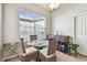 Bright breakfast nook with large windows, seating for four, and a decorative cabinet at 31820 Blythewood Way, Wesley Chapel, FL 33543