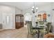 Dining room with decorative cabinet and adjacent kitchen area at 31820 Blythewood Way, Wesley Chapel, FL 33543