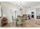 Dining area featuring a glass table, chandelier, and neutral decor at 31820 Blythewood Way, Wesley Chapel, FL 33543