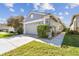 Charming single-story home showcasing well-maintained lawn, gray exterior and attached two-car garage at 31820 Blythewood Way, Wesley Chapel, FL 33543