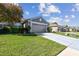 Exterior shot of single-story home on a well-manicured lawn under blue skies at 31820 Blythewood Way, Wesley Chapel, FL 33543