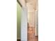 Hallway to bathroom featuring bi-fold door entrance to the bathroom at 31820 Blythewood Way, Wesley Chapel, FL 33543