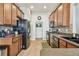 Well-lit kitchen featuring wood cabinetry, tile backsplash, and stainless steel appliances at 31820 Blythewood Way, Wesley Chapel, FL 33543