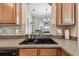 A kitchen sink with a view into the living space, and black sink basin at 31820 Blythewood Way, Wesley Chapel, FL 33543
