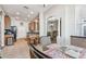 Open-concept kitchen and dining area with tile floors, stainless appliances, and breakfast bar seating at 31820 Blythewood Way, Wesley Chapel, FL 33543