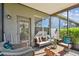 Screened-in lanai with outdoor seating and cushions at 31820 Blythewood Way, Wesley Chapel, FL 33543