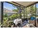 Screened-in lanai featuring outdoor furniture and plants with a view of the green backyard at 31820 Blythewood Way, Wesley Chapel, FL 33543