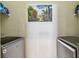 Clean laundry room with modern washer and dryer at 31820 Blythewood Way, Wesley Chapel, FL 33543