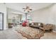 Bright living room with a ceiling fan and multiple seating areas at 31820 Blythewood Way, Wesley Chapel, FL 33543