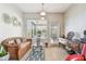 Cozy living room with natural light, comfortable seating, and decorative mirrors on the wall at 31820 Blythewood Way, Wesley Chapel, FL 33543