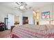Spacious bedroom with ceiling fan and open doorway to sitting room and on-suite bathroom at 31820 Blythewood Way, Wesley Chapel, FL 33543