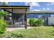 Enjoy outdoor living in this screened porch, perfect for relaxation and entertaining in a private backyard setting at 31820 Blythewood Way, Wesley Chapel, FL 33543