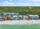 Picturesque aerial of beachfront homes featuring lush greenery and stunning ocean views at 32 Gulf Blvd, Indian Rocks Beach, FL 33785