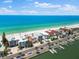 Stunning aerial view of beachfront homes with pristine white sand and turquoise water at 32 Gulf Blvd, Indian Rocks Beach, FL 33785