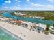 Breathtaking aerial view of beachfront homes with ocean access and lush landscaping on a sunny day at 32 Gulf Blvd, Indian Rocks Beach, FL 33785