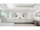 Bright bathroom featuring dual sinks, sleek white cabinetry, modern lighting, and a glass-enclosed shower at 32 Gulf Blvd, Indian Rocks Beach, FL 33785