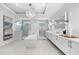 Contemporary bathroom with a standalone tub, glass-enclosed showers, dual sinks and elegant lighting at 32 Gulf Blvd, Indian Rocks Beach, FL 33785