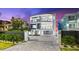 Modern, multi-story home with a sleek design, balcony views, and a paved driveway at 32 Gulf Blvd, Indian Rocks Beach, FL 33785