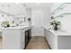 Modern kitchen area with sleek countertops, glass shelving, and wine fridge at 32 Gulf Blvd, Indian Rocks Beach, FL 33785