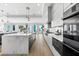 Modern kitchen featuring a large island, stainless steel appliances, and an open view of the ocean at 32 Gulf Blvd, Indian Rocks Beach, FL 33785