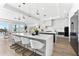 Modern kitchen with a long breakfast bar, pendant lights, and an open ocean view at 32 Gulf Blvd, Indian Rocks Beach, FL 33785