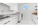 Well-lit laundry room features modern appliances and ample storage at 32 Gulf Blvd, Indian Rocks Beach, FL 33785