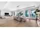 Bright, open-concept living space with an ocean view, dining area, and modern furniture at 32 Gulf Blvd, Indian Rocks Beach, FL 33785