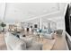 Open-concept living space featuring a modern kitchen, dining area, and comfortable seating with bright accents at 32 Gulf Blvd, Indian Rocks Beach, FL 33785
