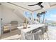 Outdoor kitchen with bar seating, grill, and stunning ocean views at 32 Gulf Blvd, Indian Rocks Beach, FL 33785